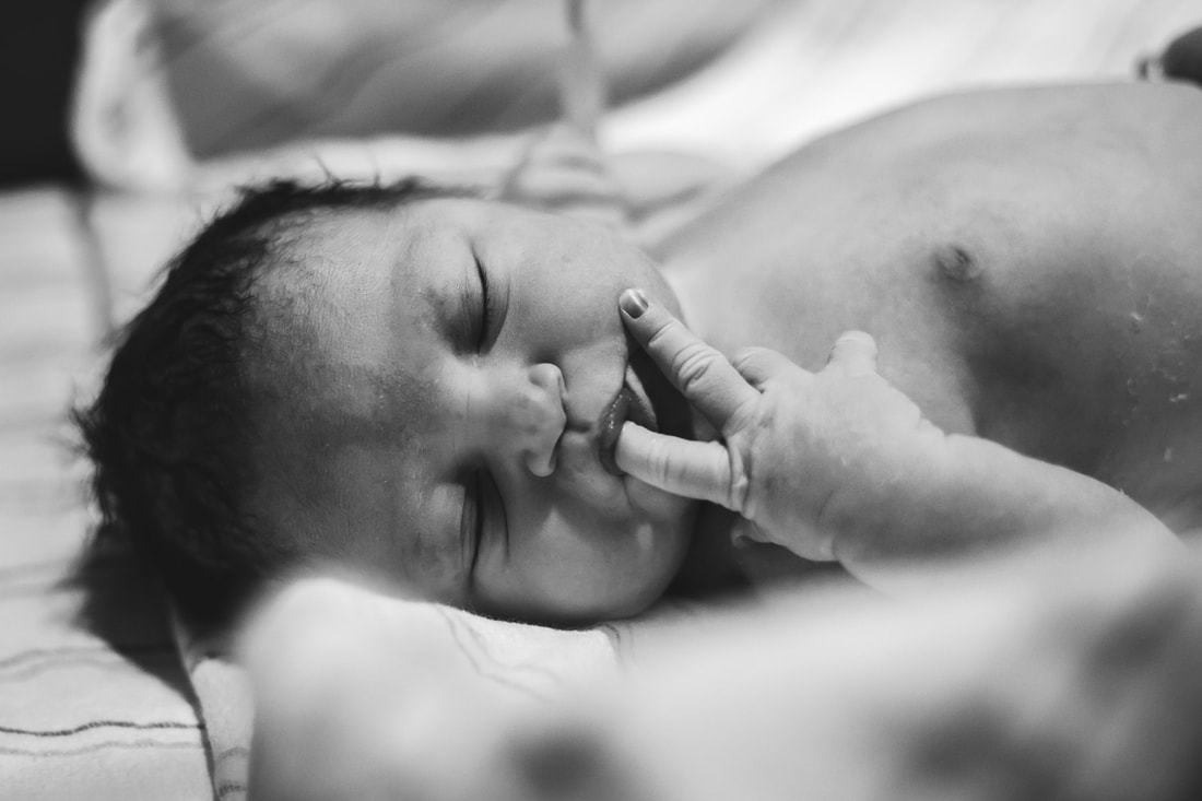 Picture of new baby at birth charleston sc birth photographer