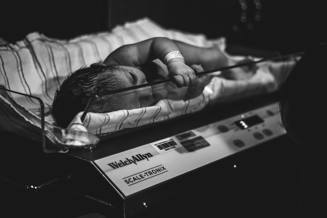 Picture of baby being weighed after birth lowcountry birth photographer