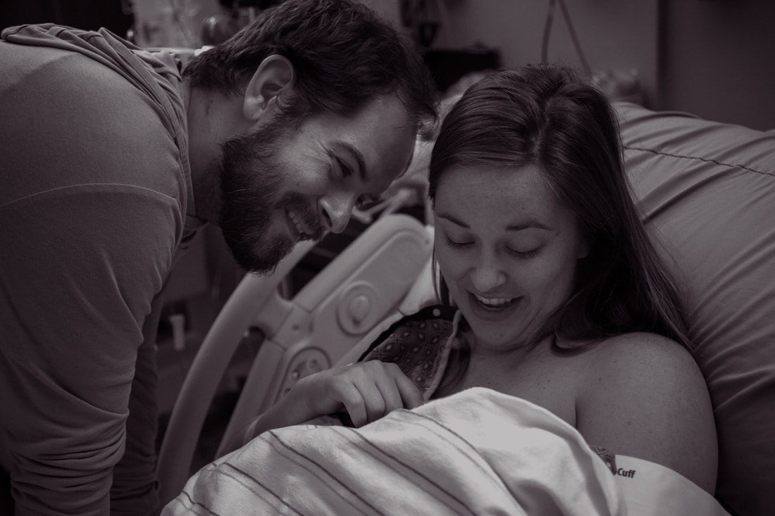 black and white photo of parents meeting their new baby after a hospital birth in Charleston, SC