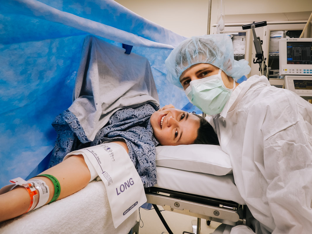 Photo of a woman and man in an operating room during a c-section birth