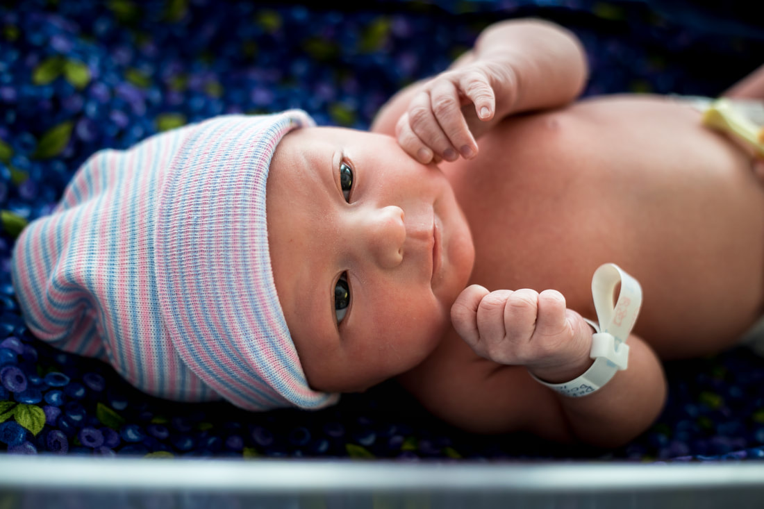 Photo of a newborn baby with hospital band - fresh 48 charleston sc hospital newborn photography
