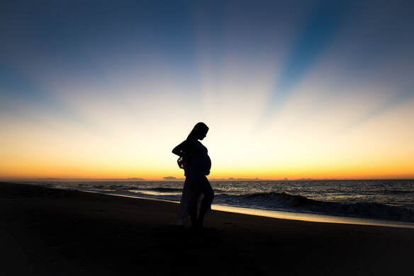 Silhoutte photo of a pregnant mother at sunrise on the beach | Maternity photographer | Charleston, SC birth and baby photographer