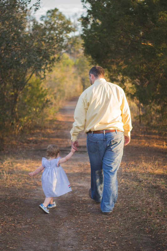Charleston, SC dad and toddler daughter walking holding hands 