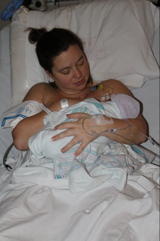 Picture of a mother holding her newborn baby in the hospital after birth